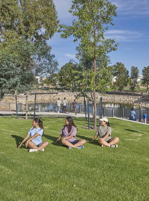 lake treeby land for sale girls sitting on grass large trees stretching yoga