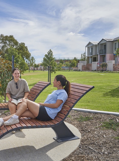 lake treeby estate land for sale girls relaxing on wooden lounge chairs two storey homes